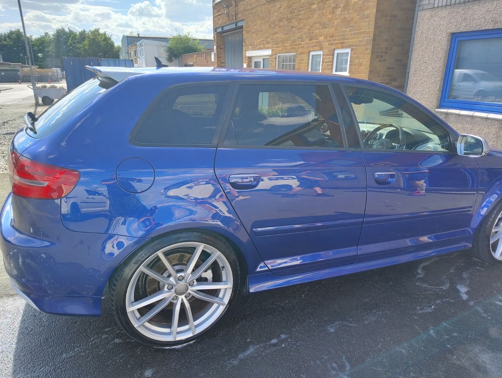 Blue Audi hatchback with mirror-finish paint after detailing